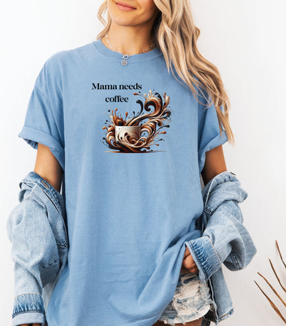 Artistic Washed Denim t-shirt design featuring a white coffee cup surrounded by dynamic swirls of coffee, cream, and espresso in rich browns and blacks. Bold and expressive "Mama needs coffee" text, this design captures the energy and chaos of caffeine cravings—perfect for moms who run on coffee and need a stylish way to show it.