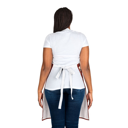 Dark red Christmas apron with white snowflakes, trees, reindeer, and festive text reading “Merry Christmas,” perfect for holiday baking and cooking.