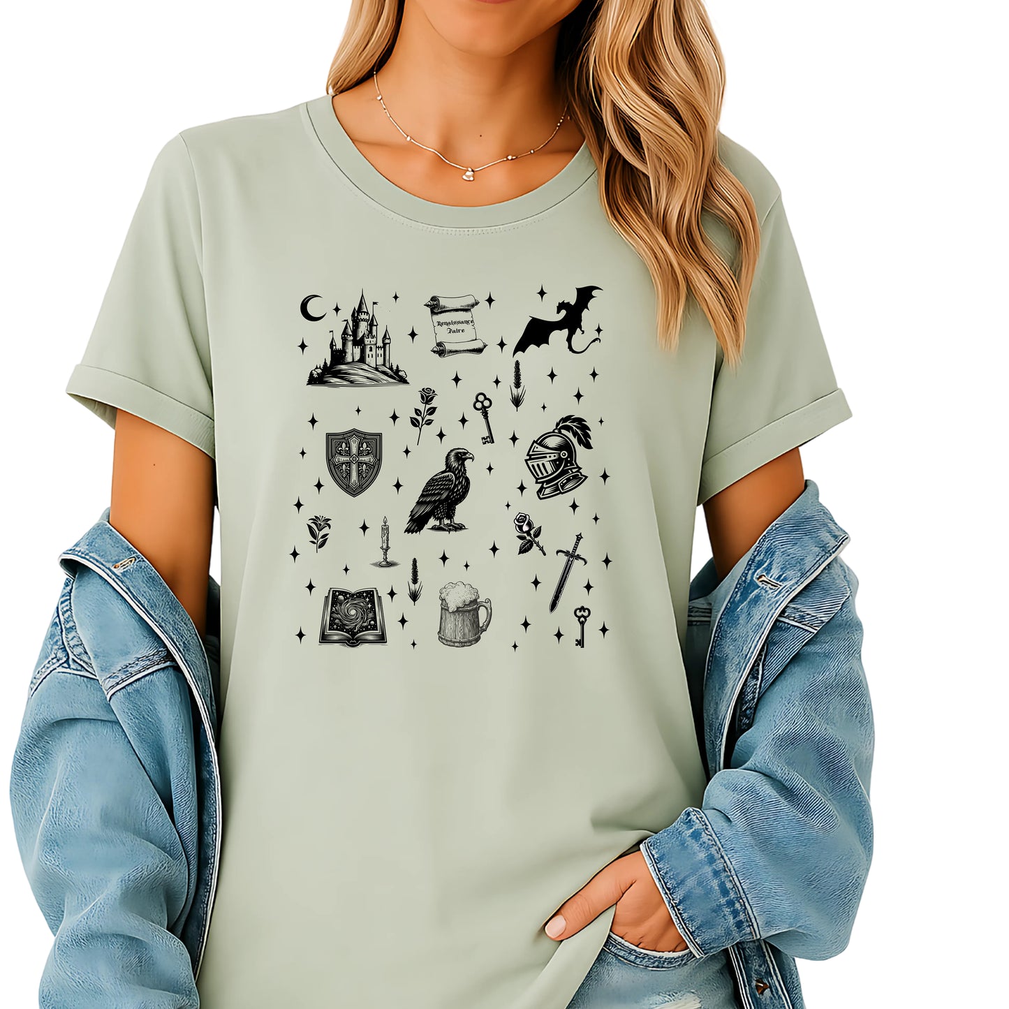 Person wearing a Citron T-shirt featuring the "Moonlit Magick" Renaissance Faire design. The shirt showcases a collection of detailed black illustrations, including a medieval castle, a dragon, knight helmet, shield, raven, spellbook, sword, key, mug of ale, and stars—capturing the enchanting spirit of medieval fantasy.