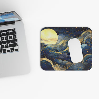 Mouse pad with celestial design next to a laptop on a white surface