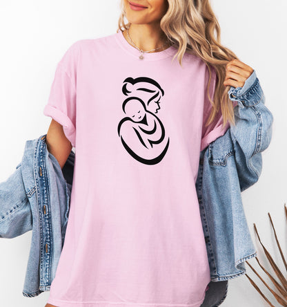 Person wearing a pink t-shirt with a black Mother and Child graphic on it