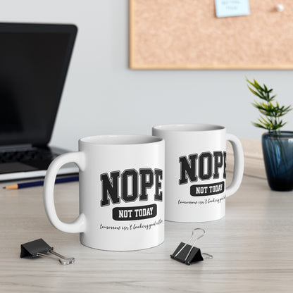 White ceramic mug with bold black collegiate text that reads “NOPE” and “NOT TODAY, tomorrow isn't looking good either” a humorous minimalist design for anyone in a not-today mood.