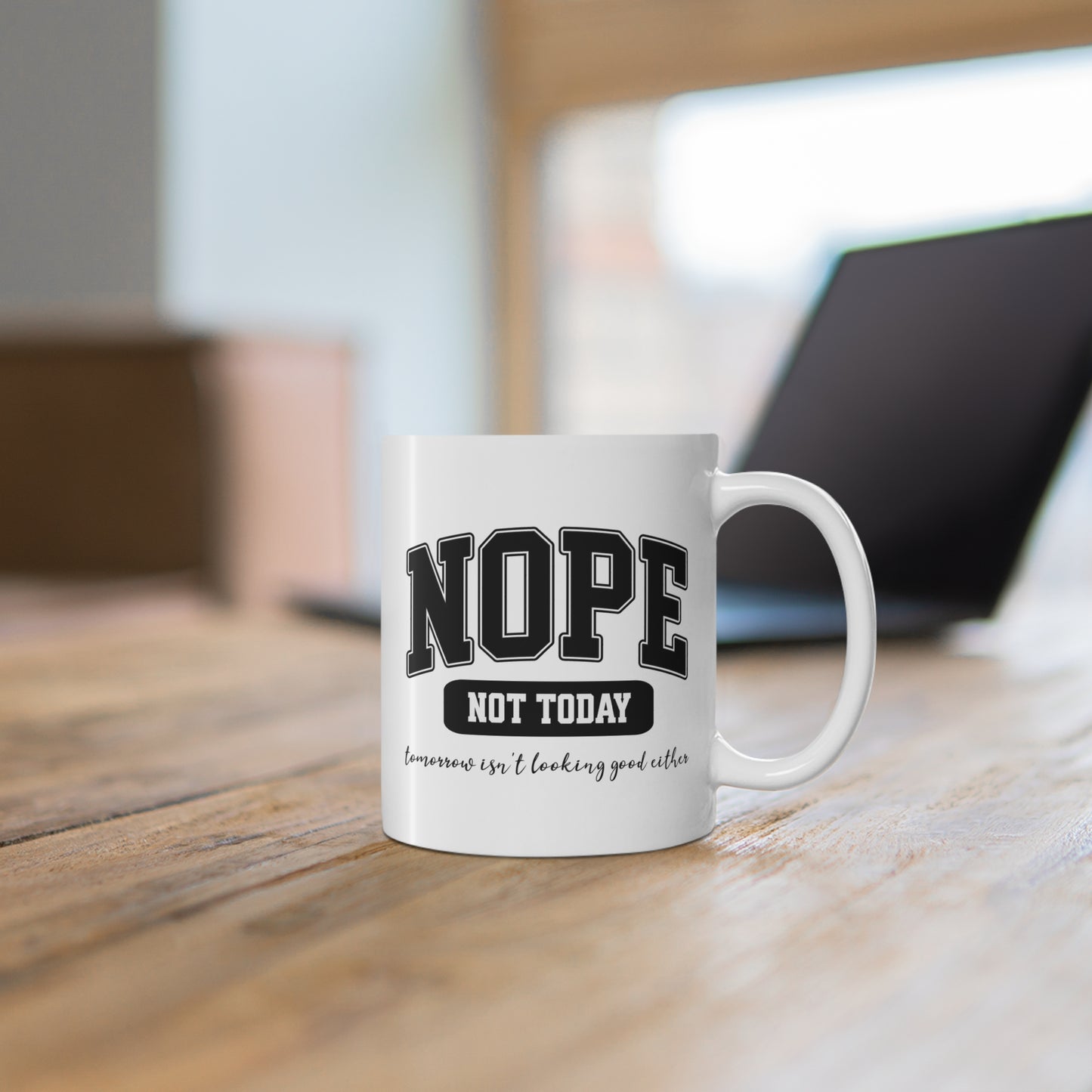 White ceramic mug with bold black collegiate text that reads “NOPE” and “NOT TODAY, tomorrow isn't looking good either” a humorous minimalist design for anyone in a not-today mood.