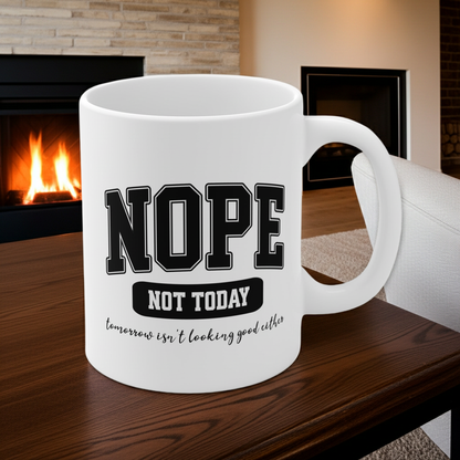 White ceramic mug with bold black collegiate text that reads “NOPE” and “NOT TODAY, tomorrow isn't looking good either” a humorous minimalist design for anyone in a not-today mood.