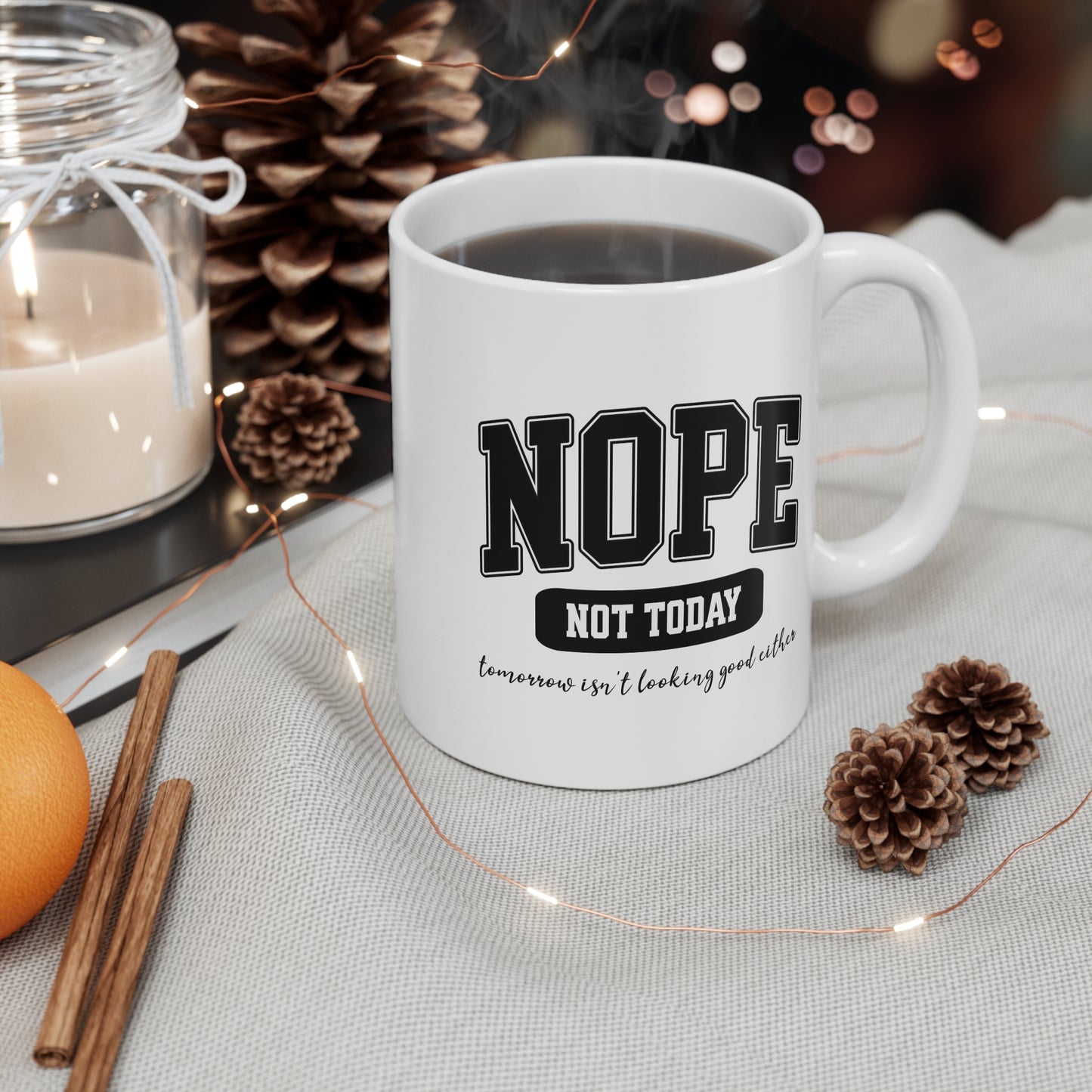 White ceramic mug with bold black collegiate text that reads “NOPE” and “NOT TODAY, tomorrow isn't looking good either” a humorous minimalist design for anyone in a not-today mood.