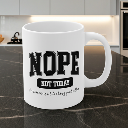 White ceramic mug with bold black collegiate text that reads “NOPE” and “NOT TODAY, tomorrow isn't looking good either” a humorous minimalist design for anyone in a not-today mood.