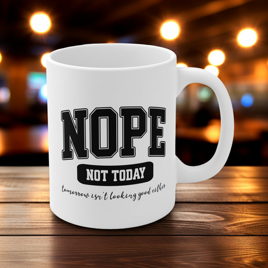 White ceramic mug with bold black collegiate text that reads “NOPE” and “NOT TODAY, tomorrow isn't looking good either” a humorous minimalist design for anyone in a not-today mood.
