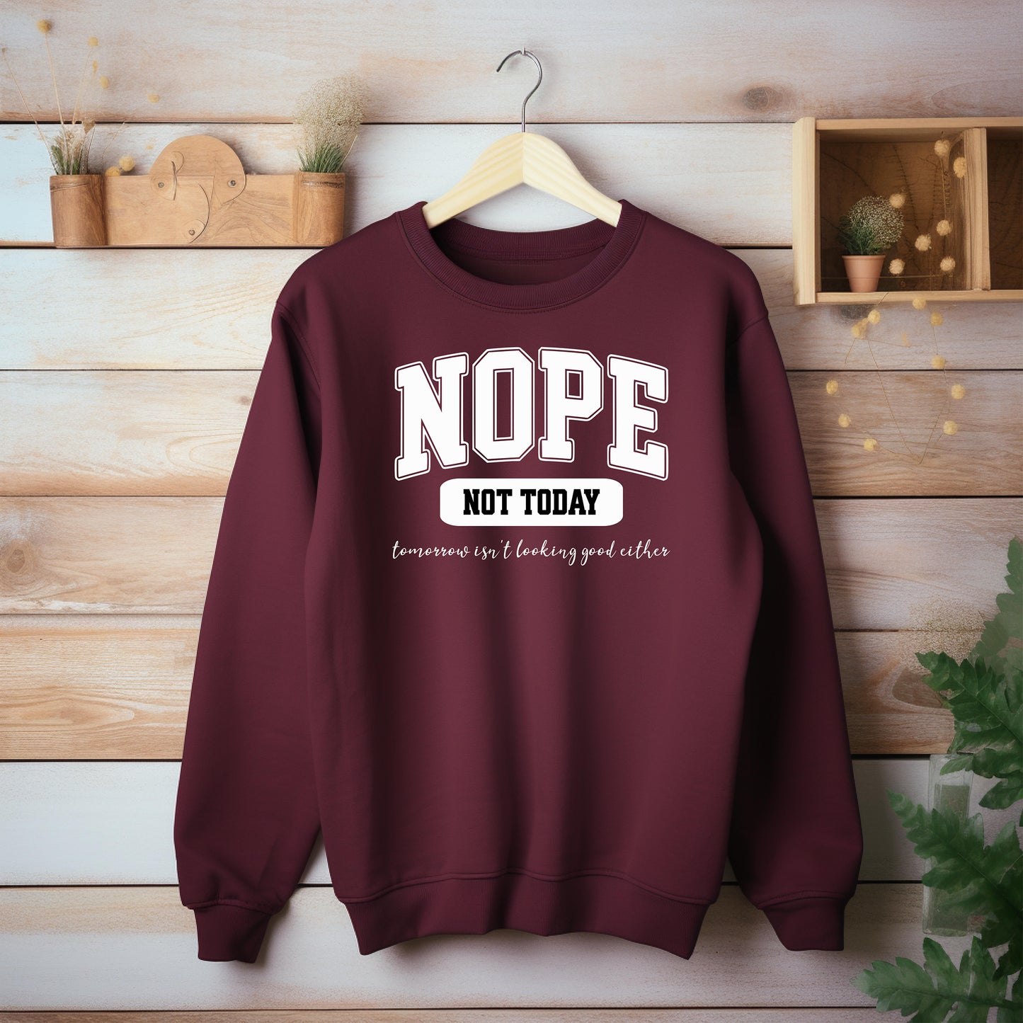 An Chili sweatshirt with bold white text reading “NOPE NOT TODAY” and smaller script “tomorrow isn’t looking good either,” a humorous casual design for lazy days.