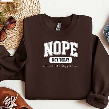 An Espresso  sweatshirt with bold white text reading “NOPE NOT TODAY” and smaller script “tomorrow isn’t looking good either,” a humorous casual design for lazy days.