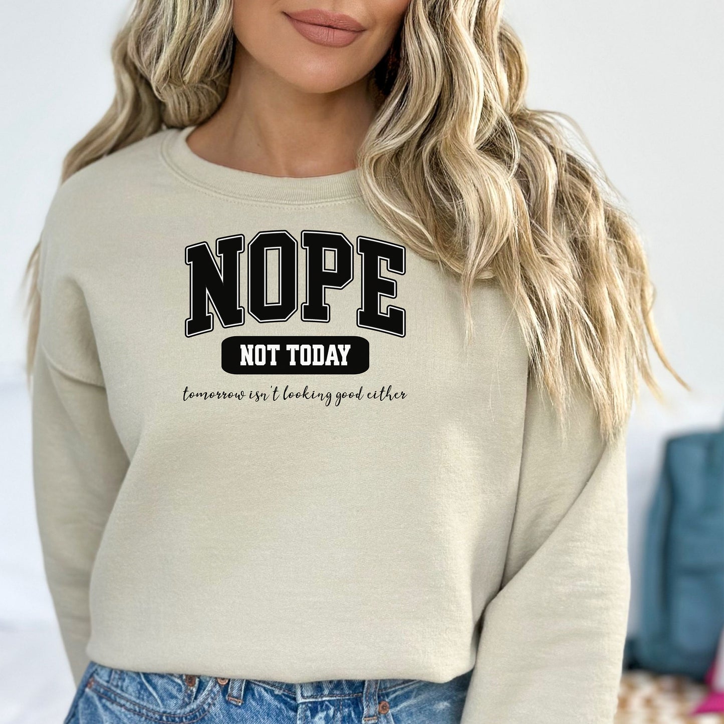 A Saned sweatshirt with bold white text reading “NOPE NOT TODAY” and smaller script “tomorrow isn’t looking good either,” a humorous casual design for lazy days.
