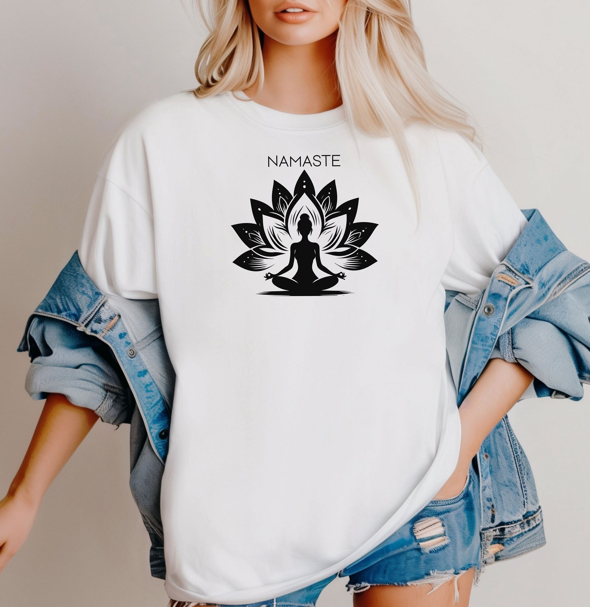 Namaste T-shirt featuring a serene yoga-inspired design with a silhouette of a person meditating in a lotus pose. Behind the figure is a stylized lotus flower, symbolizing peace, balance, and mindfulness. Printed on a soft, relaxed unisex tee, this calming graphic is perfect for yoga lovers, meditation enthusiasts, and anyone embracing a mindful lifestyle focused on inner peace and spiritual wellness.