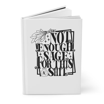 Hardcover journal with black text and design on a white background open