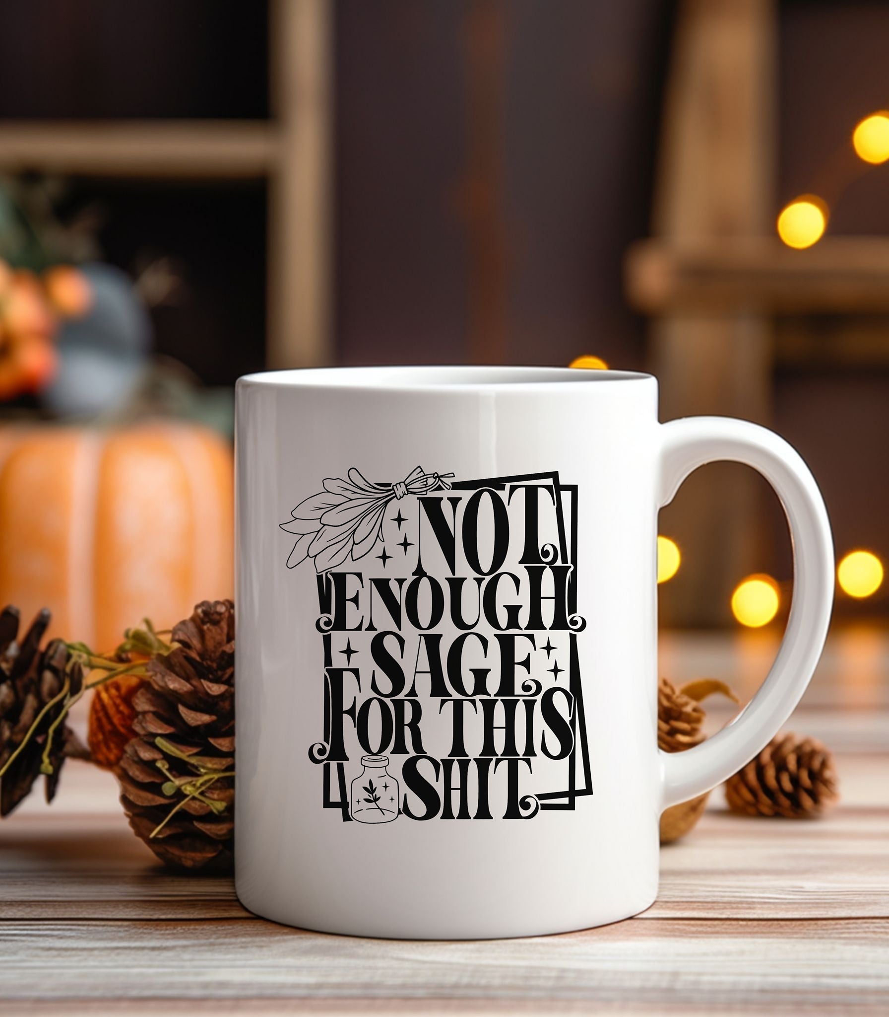 White ceramic mug featuring bold black typography reading “Not Enough Sage For This Shit,” framed in a whimsical outlined border. The design includes a detailed sage bundle illustration at the top and a small jar with a sage leaf motif at the bottom, adding a witchy, mystical vibe. Perfect for humorous coffee or tea moments, it blends sassy attitude with boho and spiritual flair, making it an ideal gift for friends with a sense of humor.