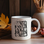 White ceramic mug featuring bold black typography reading “Not Enough Sage For This Shit,” framed in a whimsical outlined border. The design includes a detailed sage bundle illustration at the top and a small jar with a sage leaf motif at the bottom, adding a witchy, mystical vibe. Perfect for humorous coffee or tea moments, it blends sassy attitude with boho and spiritual flair, making it an ideal gift for friends with a sense of humor.