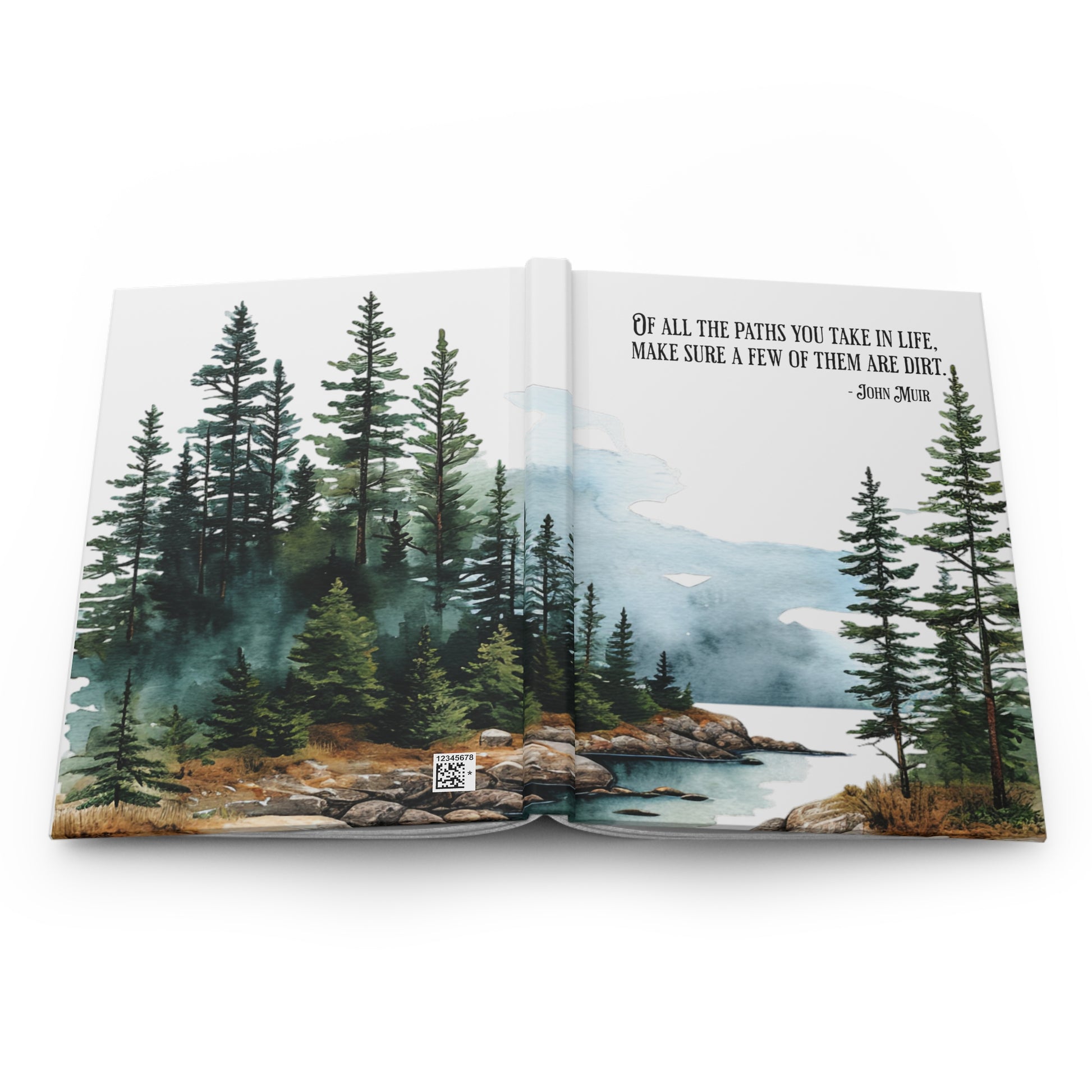 Open hardcover journal with nature-themed cover featuring trees and a lake, showing the front and back