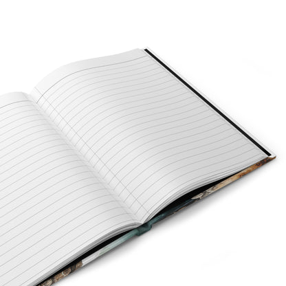 Open hardcover journal with lined pages on a white background