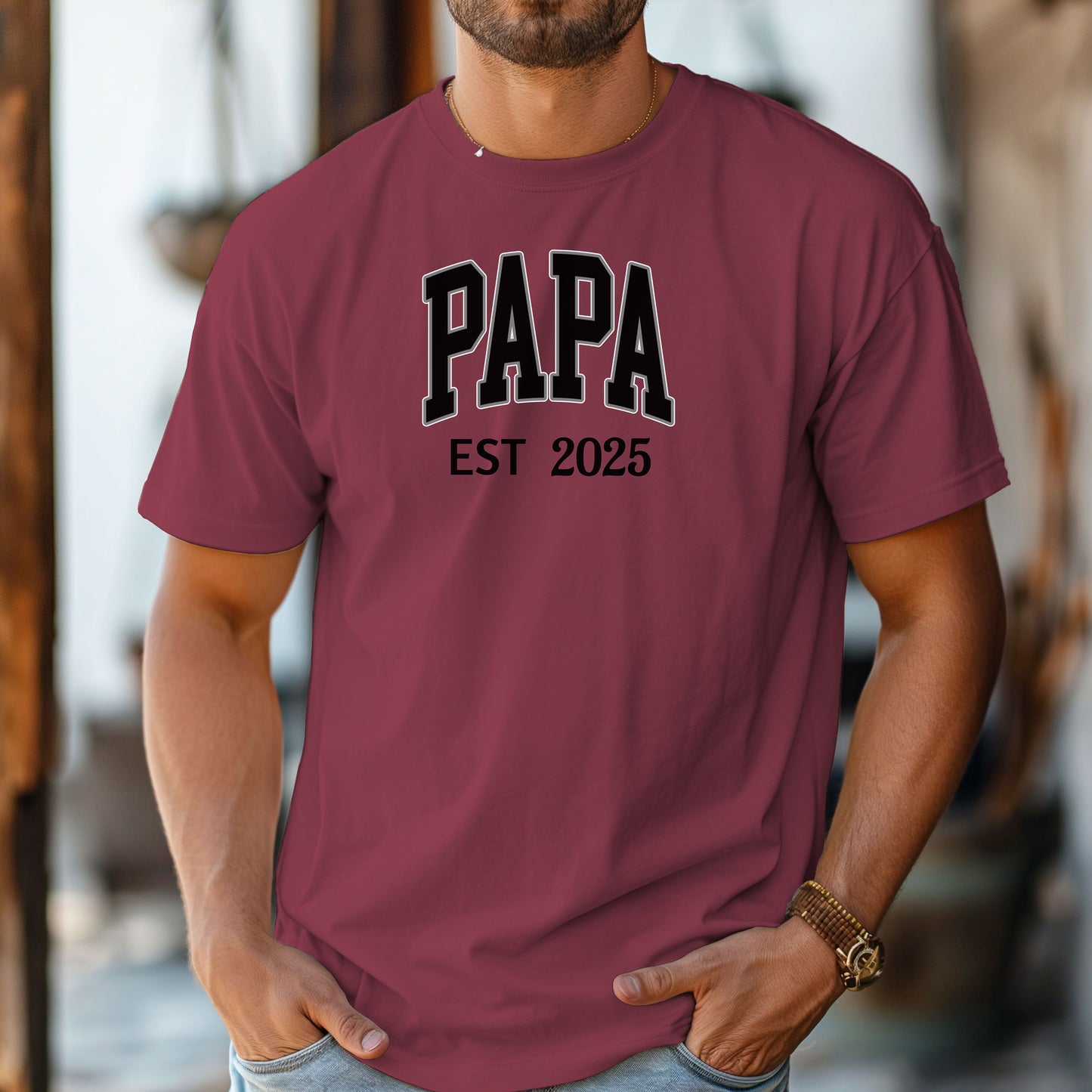 PAPA Est [Year] T-shirt featuring bold collegiate-style lettering with a customizable establishment year. Printed on a soft, relaxed-fit unisex tee in a chili color, this design makes a perfect gift for new grandfathers, Father’s Day, or family celebrations. Ideal for proudly announcing the year someone became 'Papa' while offering comfort and casual style.
