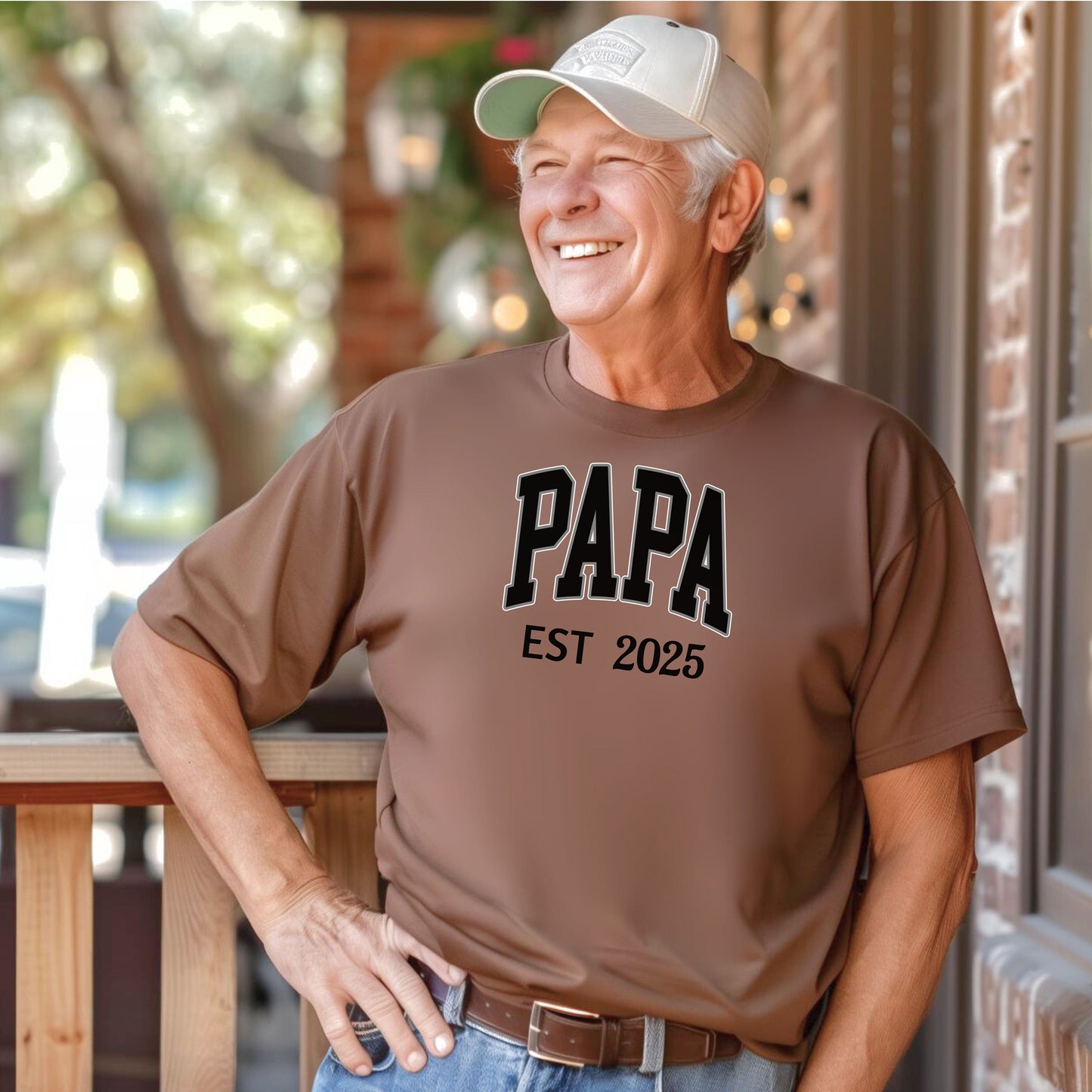 PAPA Est [Year] T-shirt featuring bold collegiate-style lettering with a customizable establishment year. Printed on a soft, relaxed-fit unisex tee in a espresso color, this design makes a perfect gift for new grandfathers, Father’s Day, or family celebrations. Ideal for proudly announcing the year someone became 'Papa' while offering comfort and casual style.