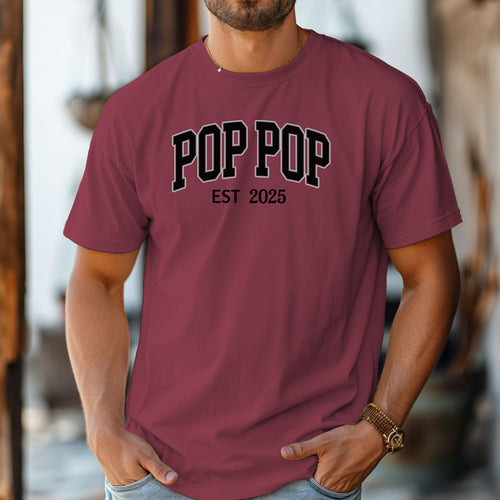 POP POP Est [Year] T-shirt featuring bold varsity-style lettering with a customizable establishment year. Displayed on a soft, chili unisex tee, this casual design is perfect for celebrating a new grandfather or marking a special year. Ideal for Father’s Day, birthdays, or family gatherings, it combines comfort with a proud, personalized statement.