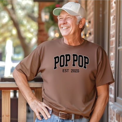 POP POP Est [Year] T-shirt featuring bold varsity-style lettering with a customizable establishment year. Displayed on a soft, espresso unisex tee, this casual design is perfect for celebrating a new grandfather or marking a special year. Ideal for Father’s Day, birthdays, or family gatherings, it combines comfort with a proud, personalized statement.