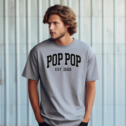 POP POP Est [Year] T-shirt featuring bold varsity-style lettering with a customizable establishment year. Displayed on a soft, granite unisex tee, this casual design is perfect for celebrating a new grandfather or marking a special year. Ideal for Father’s Day, birthdays, or family gatherings, it combines comfort with a proud, personalized statement.