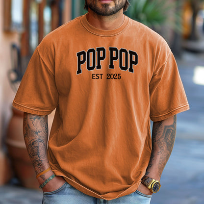 POP POP Est [Year] T-shirt featuring bold varsity-style lettering with a customizable establishment year. Displayed on a soft, yam unisex tee, this casual design is perfect for celebrating a new grandfather or marking a special year. Ideal for Father’s Day, birthdays, or family gatherings, it combines comfort with a proud, personalized statement.