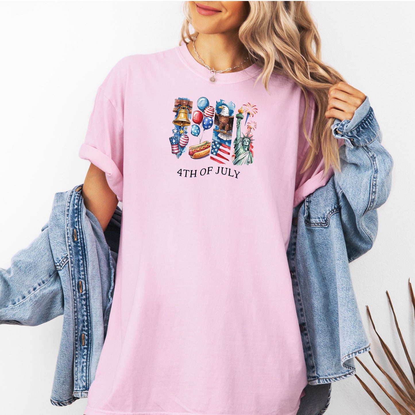 Person wearing a blossom '4th of July' themed t-shirt with graphics, paired with a denim jacket.