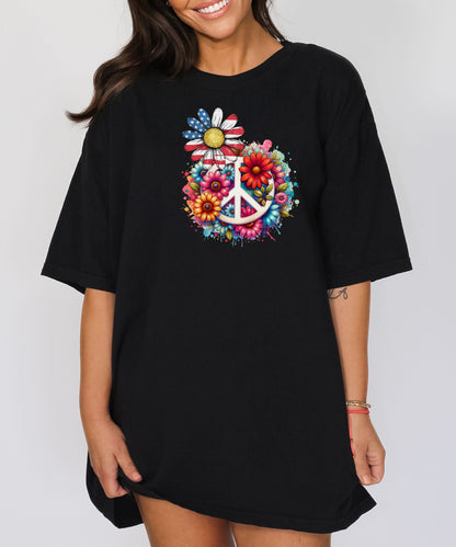 Black t-shirt featuring a vibrant retro Peace Love Liberty design with a large white peace sign surrounded by colorful flowers. A daisy with red, white, and blue American flag petals stands out, blending patriotic style with boho hippie vibes. Perfect for 4th of July, festivals, and casual summer wear.