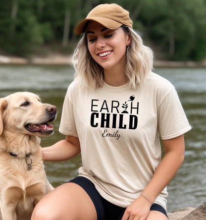 Personalized Earth Child T-shirt featuring a stylish nature-inspired design. The shirt displays the words 'EARTH CHILD' with a plant sprouting from the letter T being watered by a small watering can, symbolizing growth and love for nature. Customizable with a name below the text, this soft, casual unisex tee is perfect for eco-conscious individuals, gardeners, and free spirits who embrace a sustainable and earthy lifestyle.