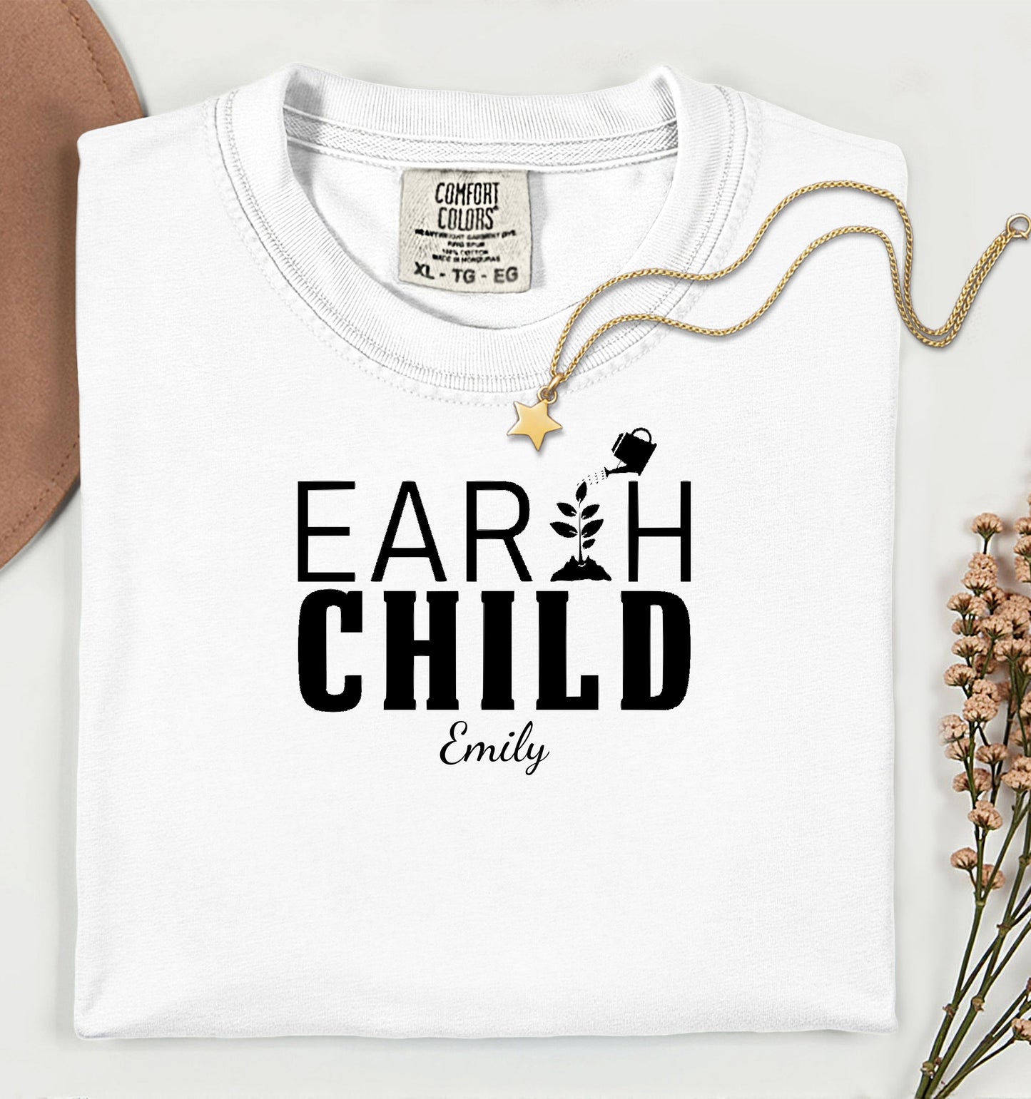 Personalized Earth Child T-shirt featuring a stylish nature-inspired design. The shirt displays the words 'EARTH CHILD' with a plant sprouting from the letter T being watered by a small watering can, symbolizing growth and love for nature. Customizable with a name below the text, this soft, casual unisex tee is perfect for eco-conscious individuals, gardeners, and free spirits who embrace a sustainable and earthy lifestyle.