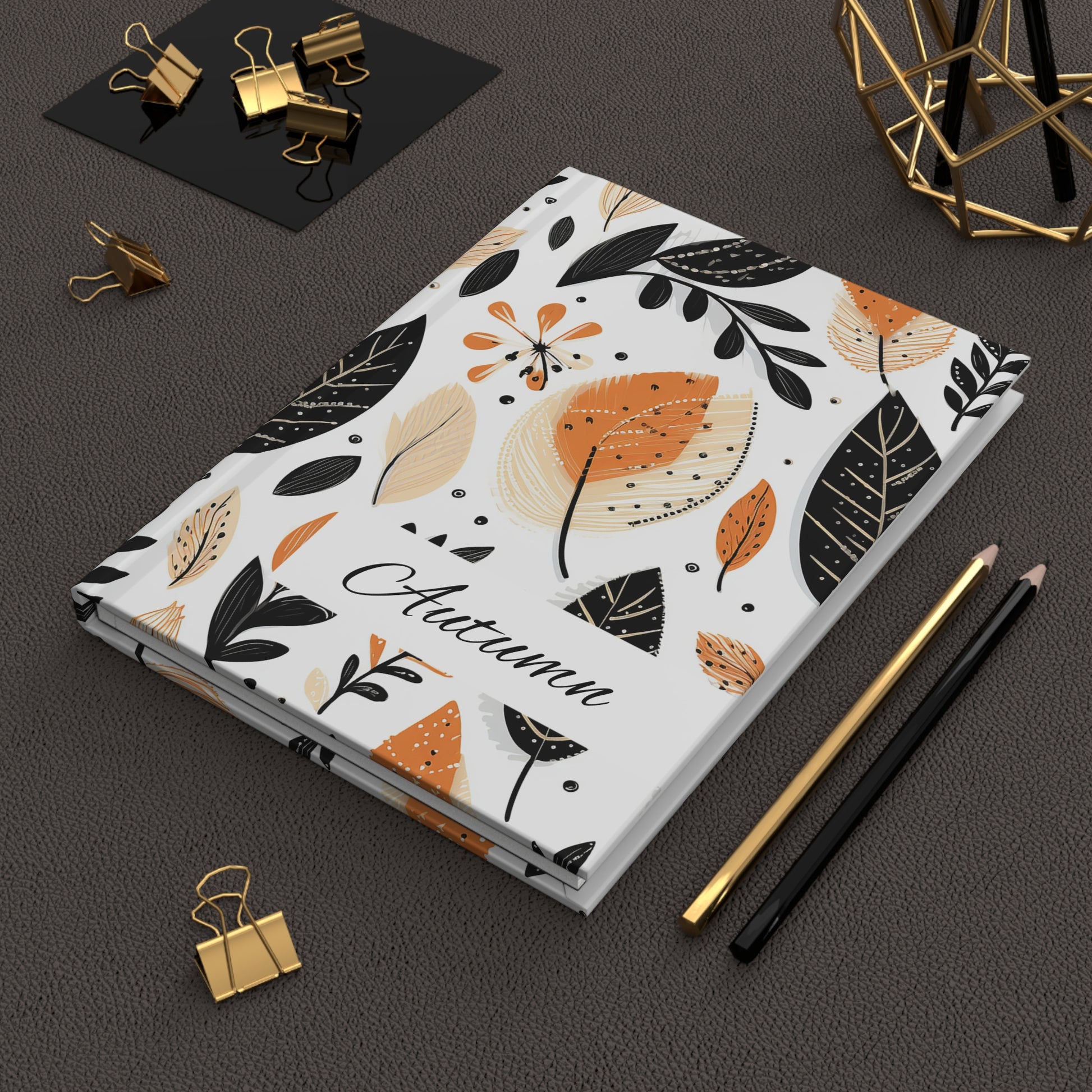Personalized Fall Leaves Hardcover Journal with autumn leaf design on a dark surface with stationery items.