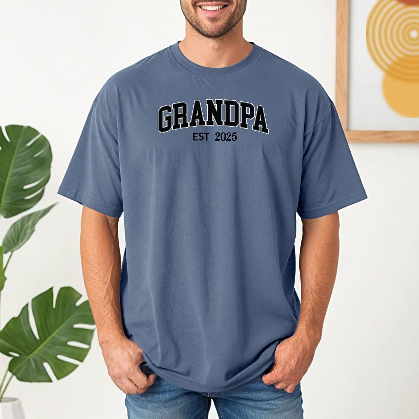 Blue Jean t-shirt featuring a bold collegiate-style 'GRANDPA EST [Year]' design in black and white lettering. Perfect gift for new grandfathers to celebrate the year they became a grandpa. A thoughtful, casual, and comfortable shirt ideal for Father's Day, family gatherings, or everyday wear.