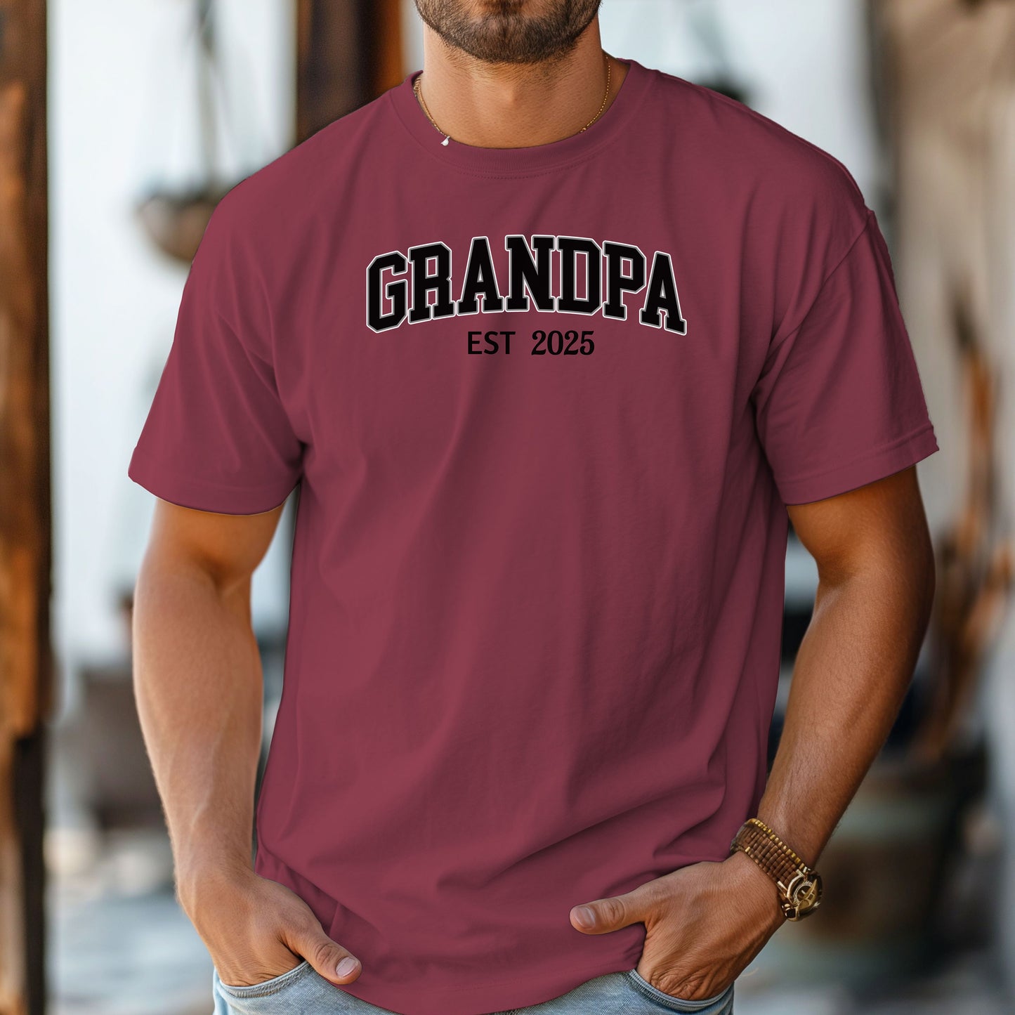 Chili t-shirt featuring a bold collegiate-style 'GRANDPA EST [Year]' design in black and white lettering. Perfect gift for new grandfathers to celebrate the year they became a grandpa. A thoughtful, casual, and comfortable shirt ideal for Father's Day, family gatherings, or everyday wear.