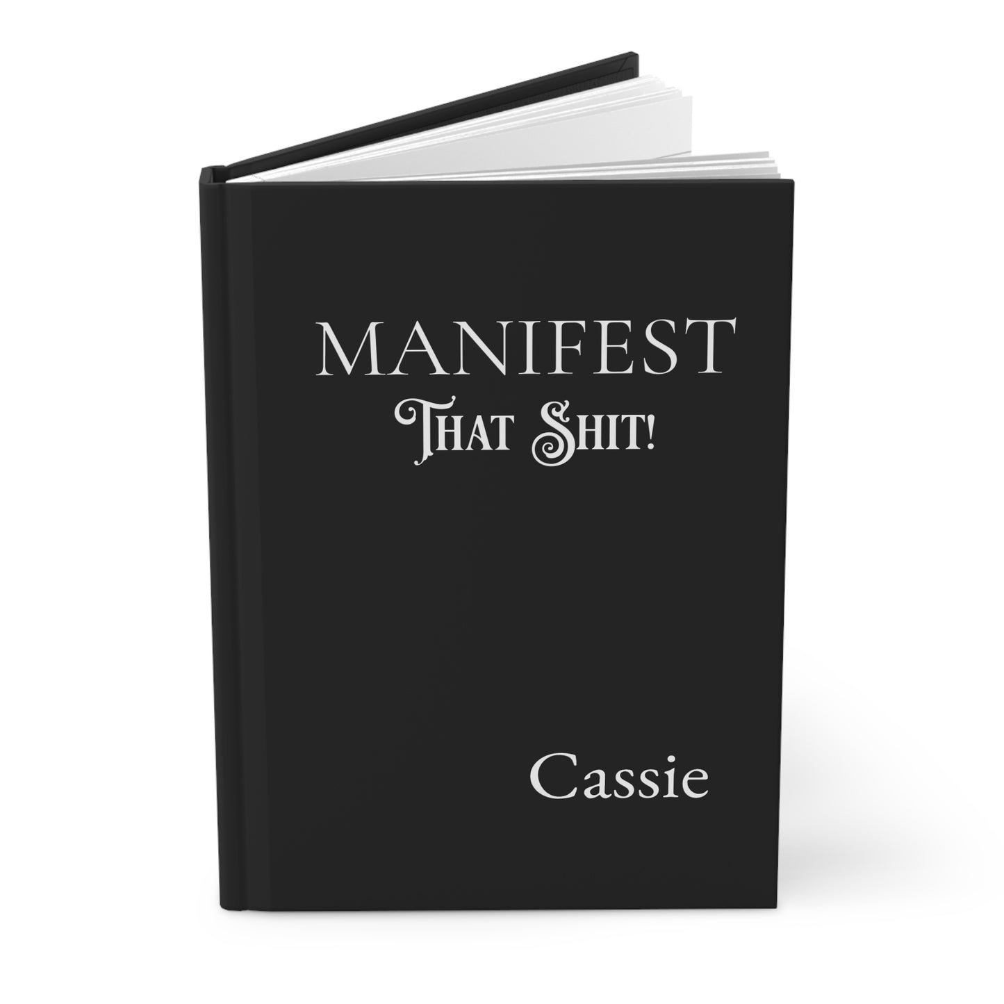 Personalized open hardcover journal with 'Manifest That Shit!' and name on a white background