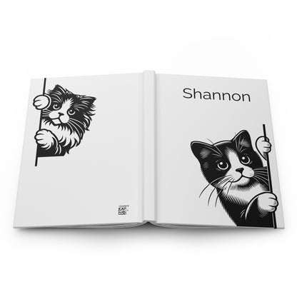 Open book lying flat with front and back covers showing with black and white illustrations of cats on a white background