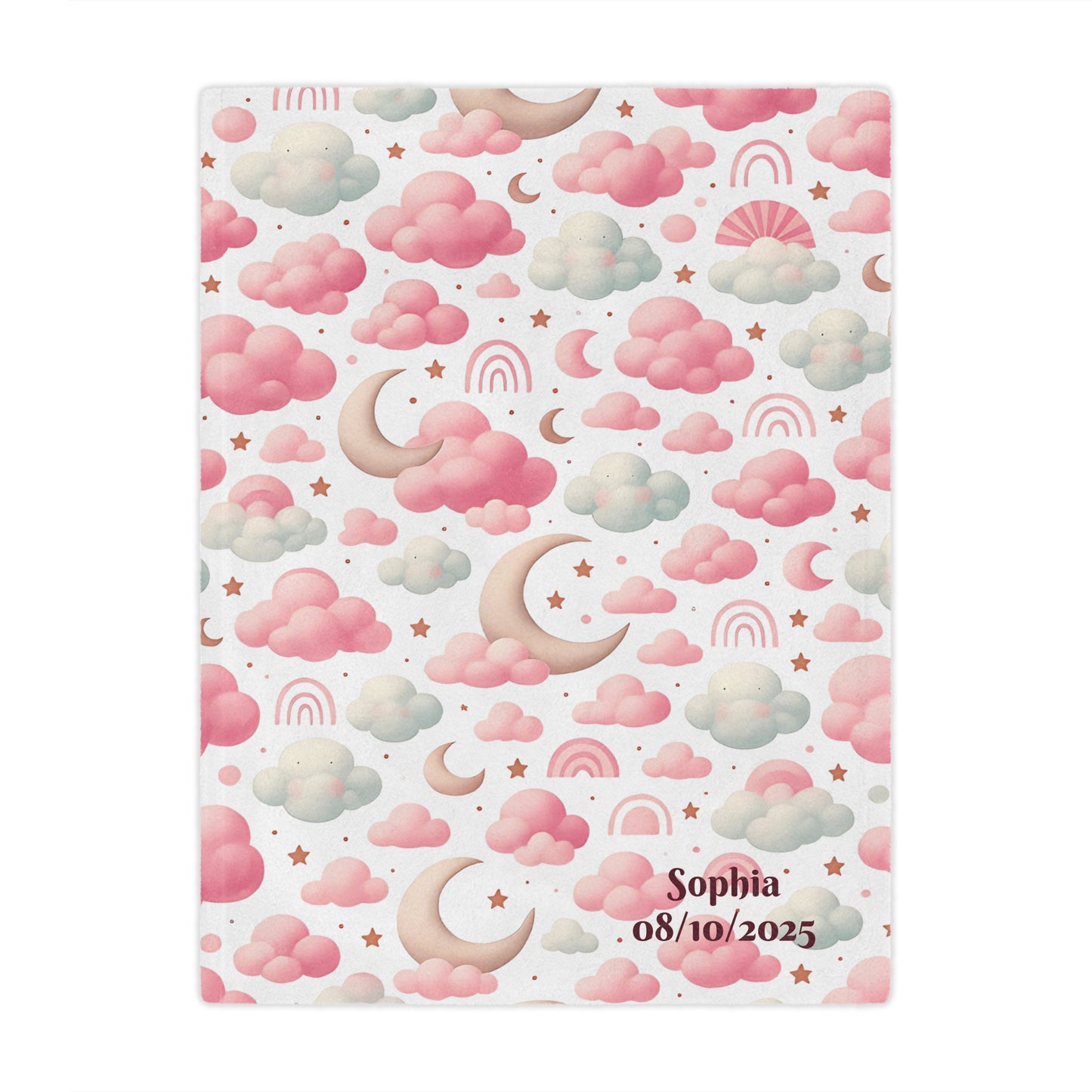Personalized baby blanket with clouds, stars, and pink rainbow pattern on a bed.