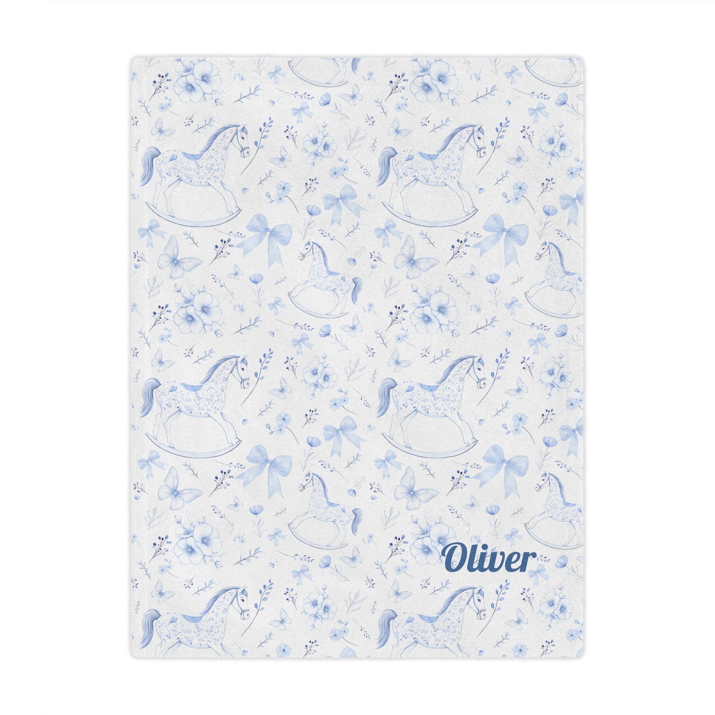Personalized Rocking Horse Minky blanket with blue chinoiserie patterns and 'Oliver' text on a bed in a bedroom.