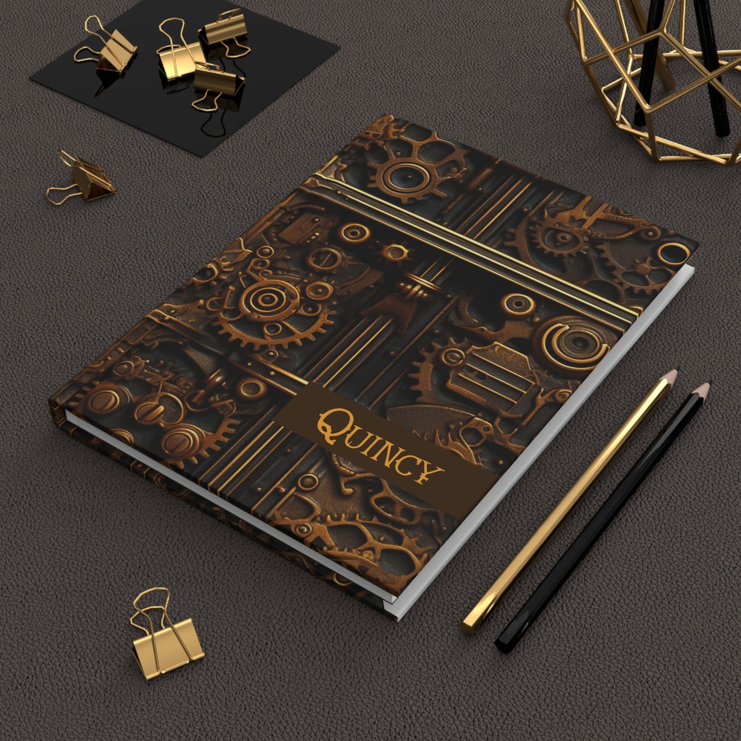 Hardcover Journal laying on a dark surface with office supplies.