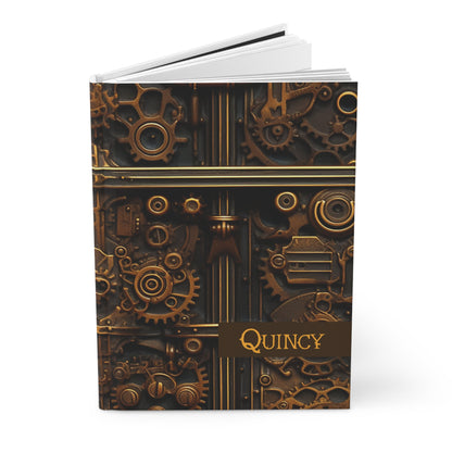 Hardcover journal with steampunk design and 'Quincy' name opened on a white background