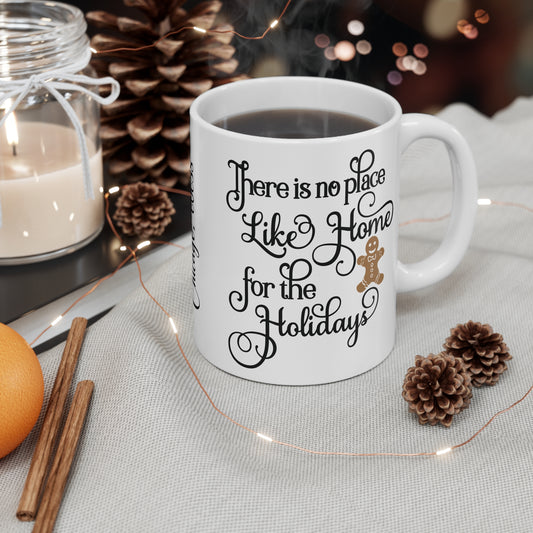 White ceramic mug with holiday-themed text on a table with decorative items