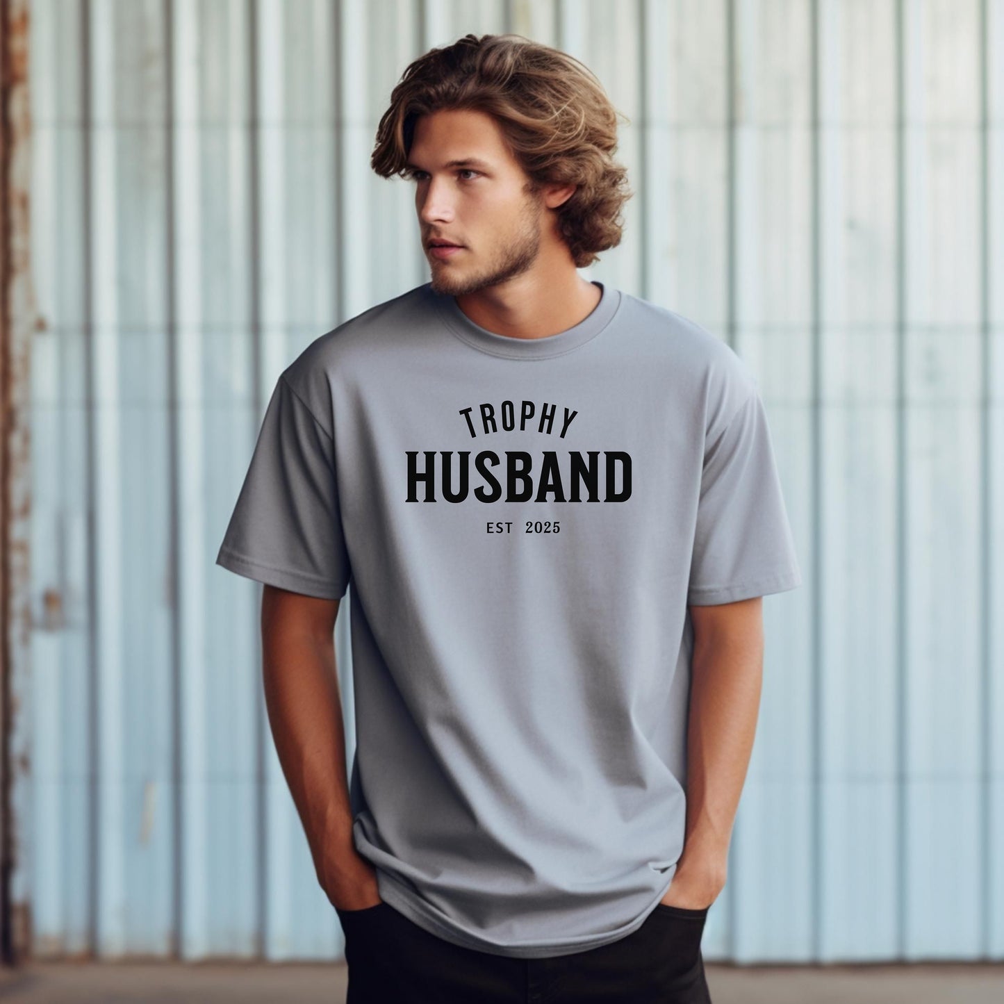 Granite Trophy Husband EST [Year] graphic T-shirt featuring bold black typography on a casual crewneck shirt. Perfect gift for newlyweds, anniversaries, grooms, or husbands with a sense of humor. Comfortable, stylish, and great for everyday wear or special occasions to celebrate marriage and fun couple vibes.