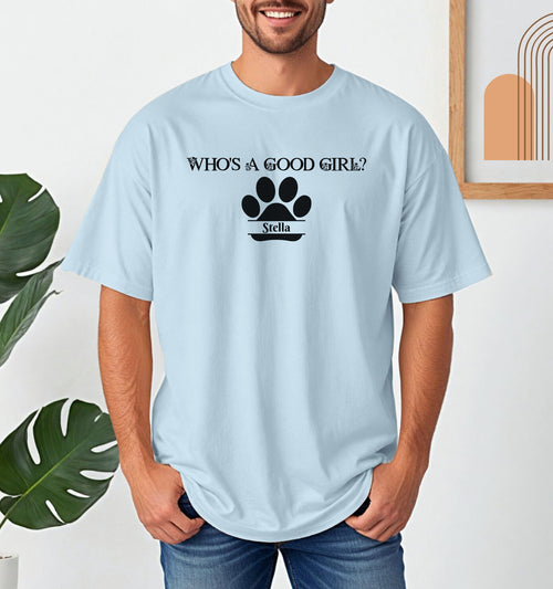 Man wearing a Chambray (light blue) t-shirt that reads “Who’s a Good Girl?” above a black paw print graphic with the name “Stella”. The shirt is a playful and heartwarming tribute to a beloved pet—perfect for dog Dads and puppy lovers.