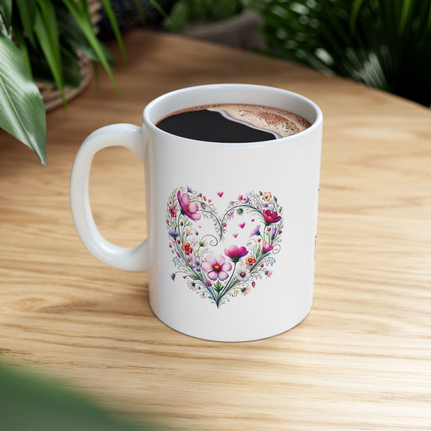 White mug with floral wildflower boho heart design on a wooden table