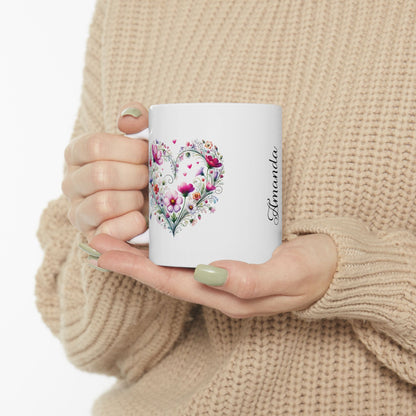 Person holding a ceramic mug with a boho floral heart design and name Amanda' on a white background
