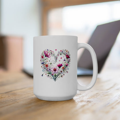White ceramic mug with a floral wildflower boho heart design on a wooden surface