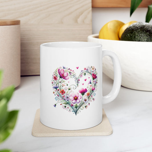White ceramic mug with floral wildflower heart design on a coaster, placed on a kitchen counter