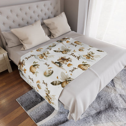 Personalized Woodland Animal Minky Nursery Blanket with 'Jack' name pattern draped over a bed in a bedroom setting