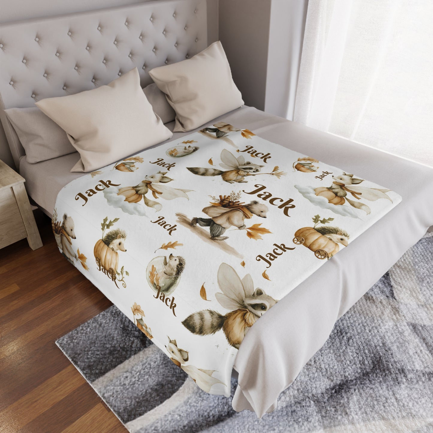Personalized Woodland Animal Minky Nursery Blanket with 'Jack' name pattern draped over a bed in a bedroom setting