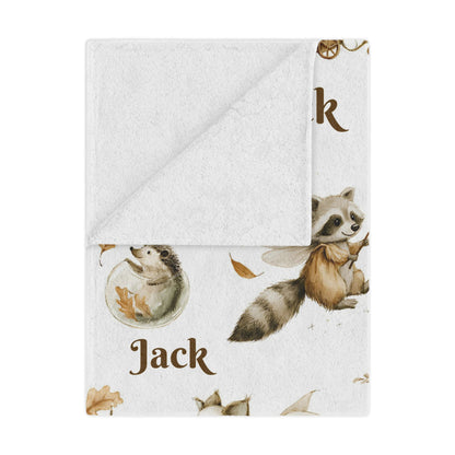 Personalized Woodland Animal Minky Nursery Blanket with 'Jack' name pattern draped over a bed in a bedroom setting