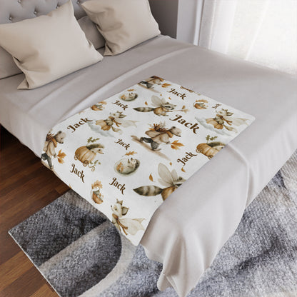 Personalized Woodland Animal Nursery Minky Blanket with 'Jack' name pattern draped over a bed in a bedroom setting